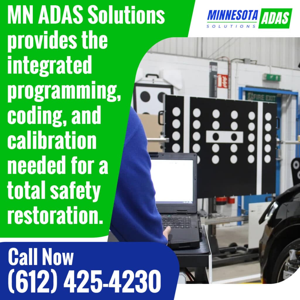 Technician using a laptop and calibration targets at Minnesota ADAS Solutions for vehicle programming, coding, and ADAS calibration