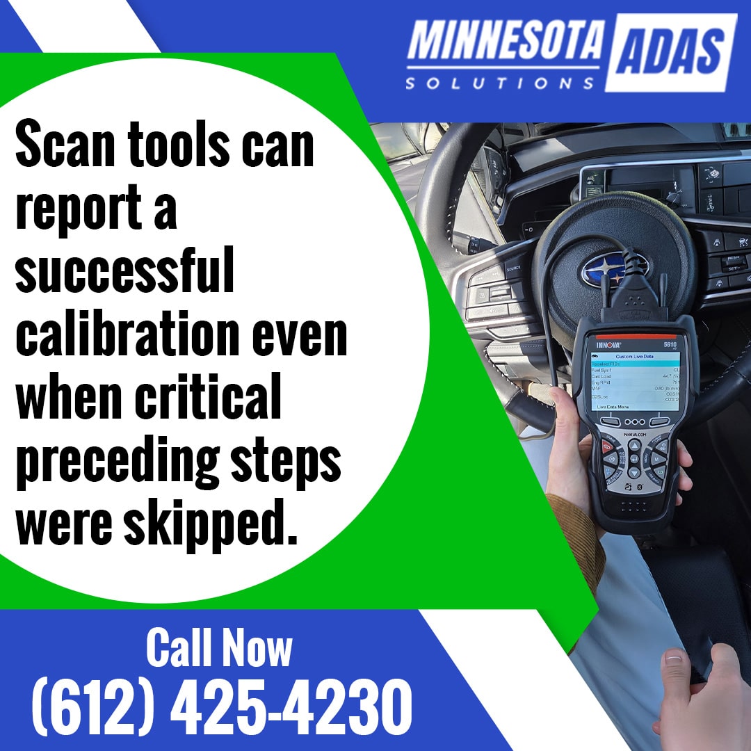 Technician holding an automotive OBD diagnostic scan tool connected inside a vehicle at the steering wheel.